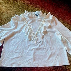 White shirt high neck. Ruffles on the wrist of blouse.